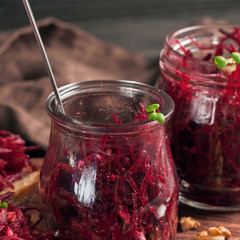 Salad of beets and walnuts in a jar of glass