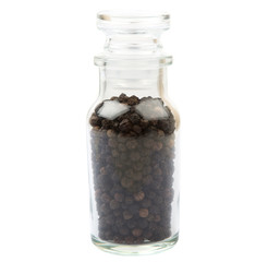 Black peppercorn in glass vial over white background