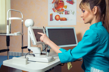 woman doctor works at the tocuh screen computer in cabinet