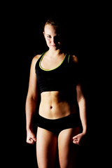 Fototapeta na wymiar Young athletic woman in black sports underwear