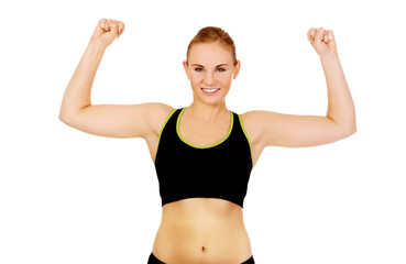 Young athletic woman showing muscles