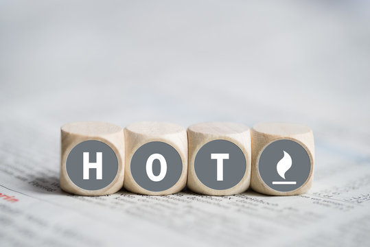 cubes with the word "hot" on a newspaper