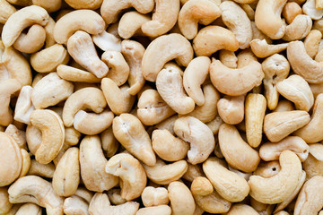 Top view of a lot of cashew nuts macro or close up background or texture