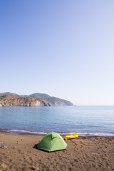 Tent set up for camping by a river