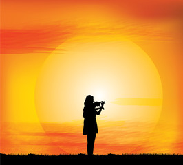 Silhouette of the girl play violin on a background of the evening