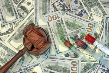 Judges Gavel And Syringe With Injection On Dollar Cash Backgroun