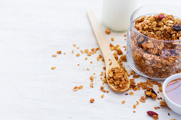 Healthy breakfast. Freshly Granola with milk and honey on a whit