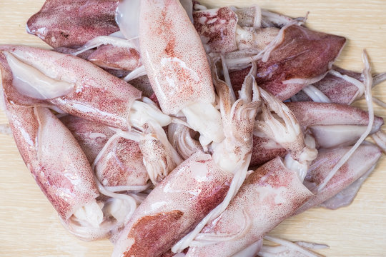 Group of squid on wooden table