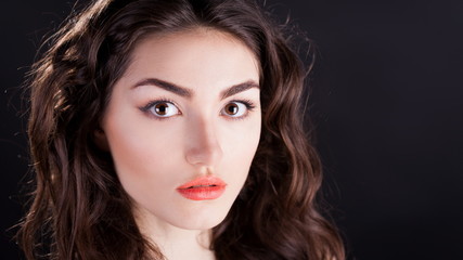 Fototapeta premium Alyona, serious face with brown eyes, black background