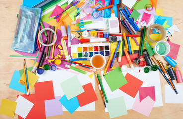 Child drawing top view. Artwork workplace with creative accessories. Flat lay art tools for...