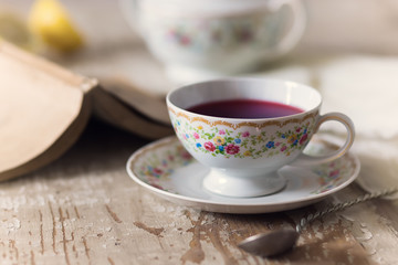Fototapeta na wymiar Cup of tea on wooden table. vintage scene.
