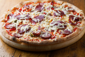 Delicious pizza with salami, tomatoes
