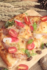 Italian pizza is delicious on wood background.