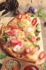 Italian pizza is delicious on wood background.