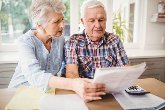 Worried Senior Couple Checking Their Bills