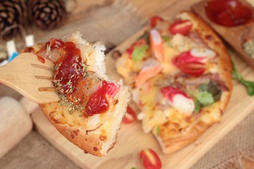 Italian pizza is delicious on wood background.