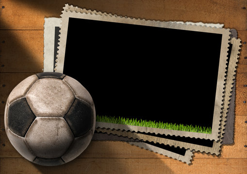 Football - Old Photo Frames with Soccer Ball / A stack of old vintage and blank photo frames with an old soccer ball (football). On a wooden background