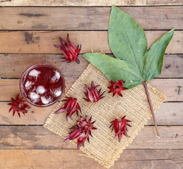 Top view - Glass of cold roselle juice on wood