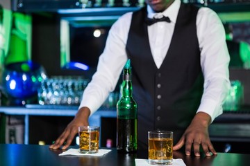 Two glasses of whiskey on bar counter