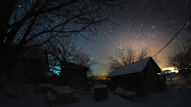 Time lapse of alternation of starry night and sunny day in a winter garden. Seamless loopable sequence