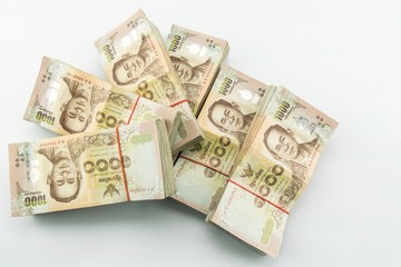 Obraz na płótnie Canvas stack of 1000 bath Thai money : Thailand Currency 1000 Bath, BankNotes isolated on white background. 
