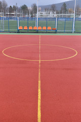 Soccer field made from red granule rubber. Football field backgr
