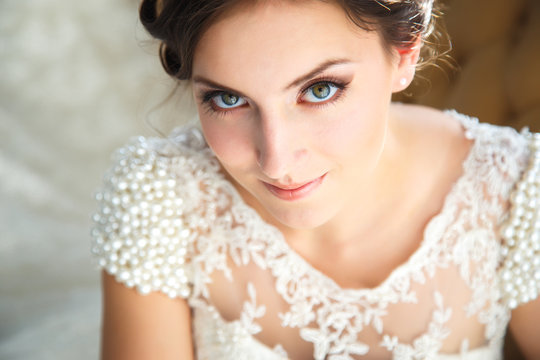 beautiful brunette bride in a luxurious wedding dress in elegant expensive interior