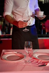 Waiter setting a table