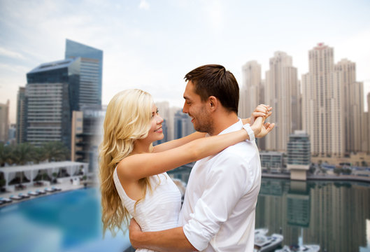 Happy Couple Hugging Over Dubai City Background