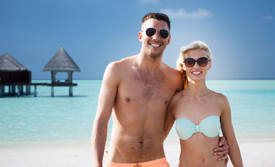 Fototapeta premium happy couple in swimwear hugging on summer beach