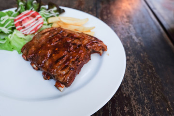Grilled steak - Grilled meat ribs on the plate with hot sauce