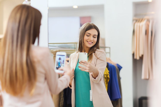 Woman Taking Mirror Selfie By Smartphone At Store
