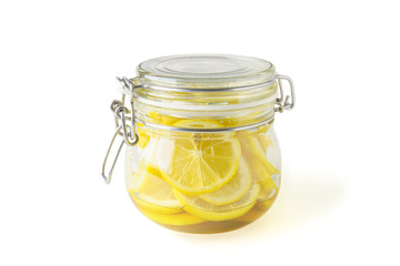 Jar of lemons on a white background