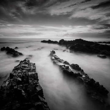 Fototapeta Long exposure and black and white image of Rocky Beach.Slightly noise and soft focus.