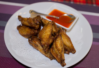 Chicken fried dish with chilli sauce.