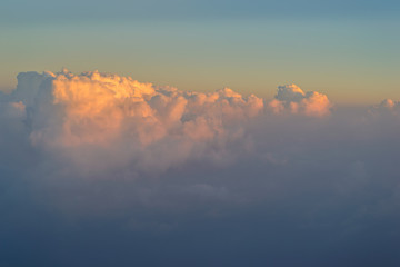 sky with clouds at sunset or sunrise. take photo from windows of airplane