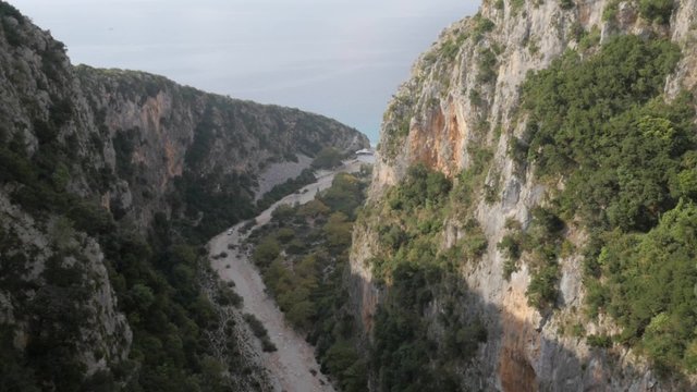 Aerial view rocky mountains cliff opening to the Adriatic sea
