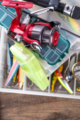 fishing tackles on boxes with different lures