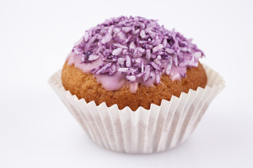 Cupcake with pink icing and sprinkles on white