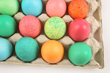 Fototapeta na wymiar Colourful painted easter eggs in egg carton