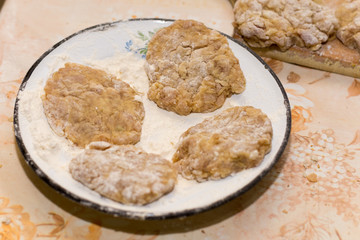 Prepared meatballs for frying on the kitchen table