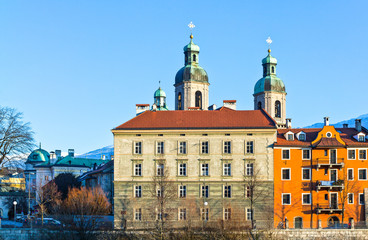 Austria,  Innsbruck,  sunset view of the old palaces with  the San Giacomo Cathedral towers on the Inn river bank