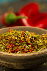 Red hot chili pepper on vintage black table. Colorful dried natural herbs and spices.