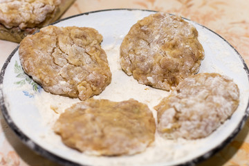 Prepared meatballs for frying on the kitchen table