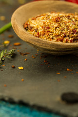 Red hot chili pepper on vintage black table. Colorful dried natural herbs and spices.