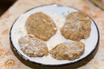 Prepared meatballs for frying on the kitchen table