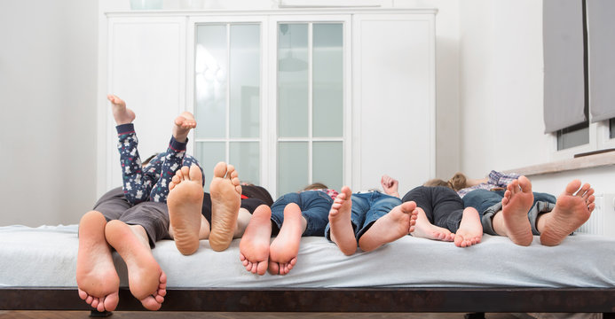 Feet of a family in bed 