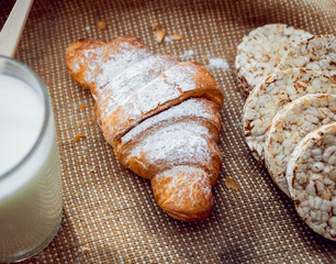 Beautiful breakfast. Milk, bread and croissant.