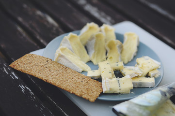 Blue cheese with crisp on wooden table marco