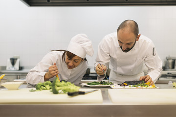 Two professionals chefs cooking together.